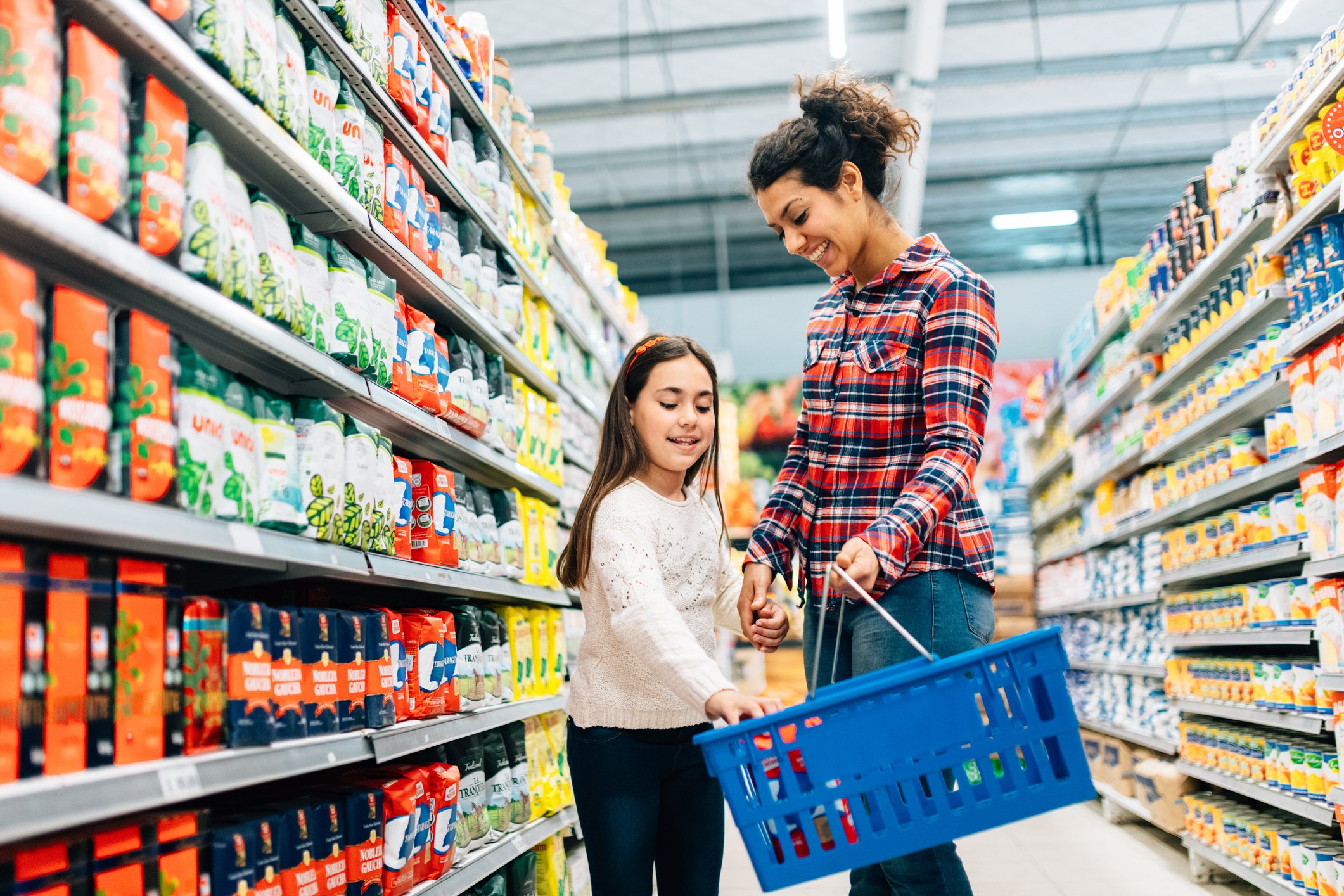 A woman and girl shopping in a supermarket.