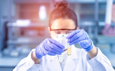 Female scientist holding 2 test tubes