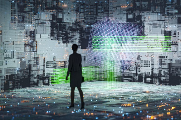 A person standing in a room with every surface covered in screens of data.