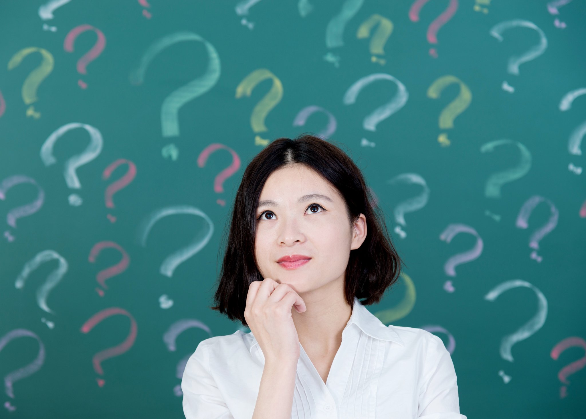 Woman surrounded by question marks