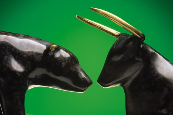 Bull and bear figurines standing face-to-face