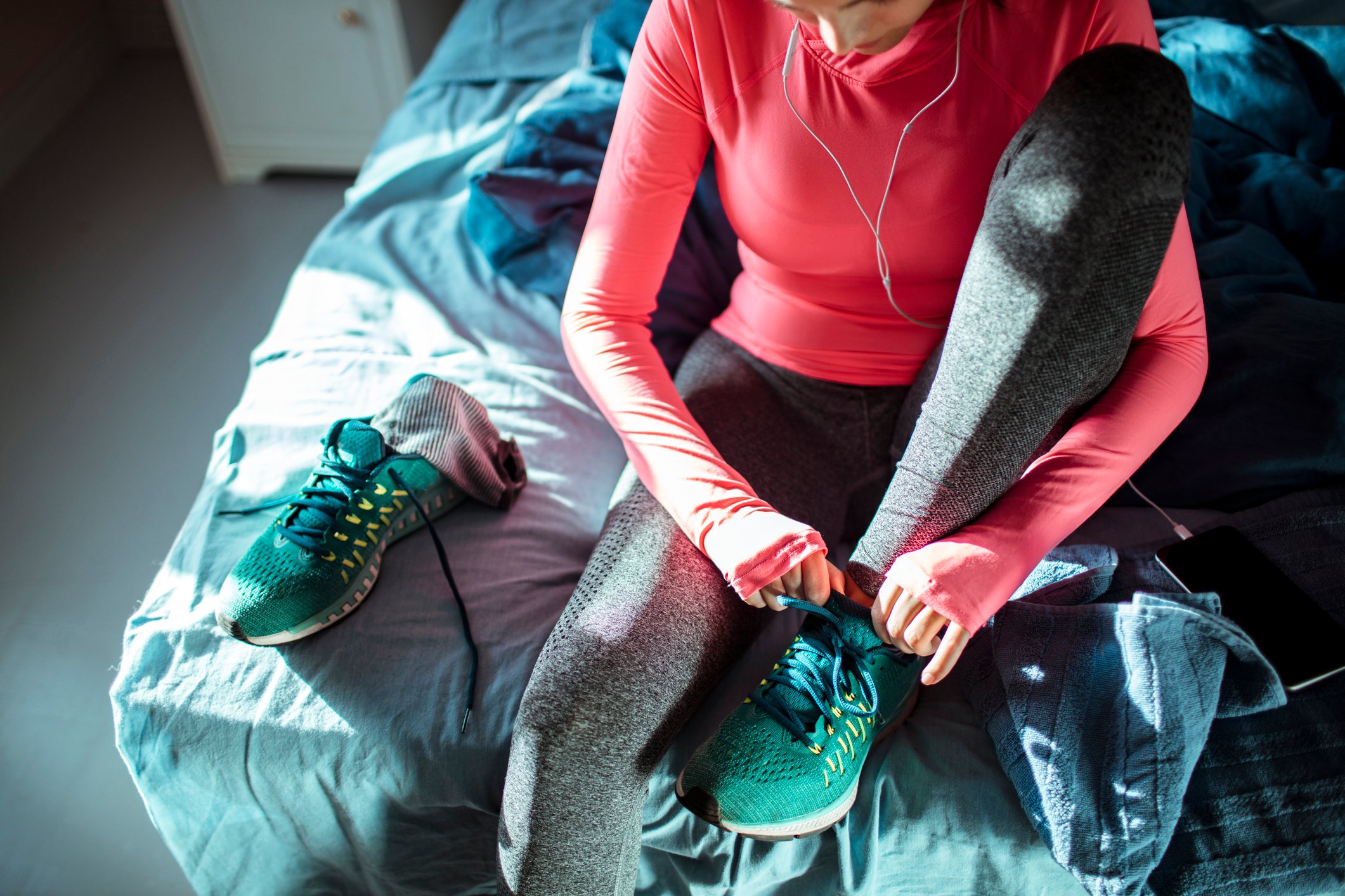 Woman in fitness apparel tying shoes