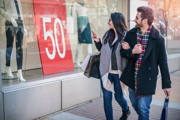 Couple browsing items on sale. 