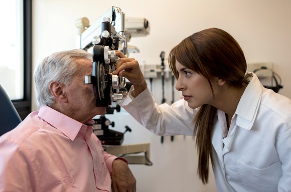 Patient getting an eye exam by an optometrist. 