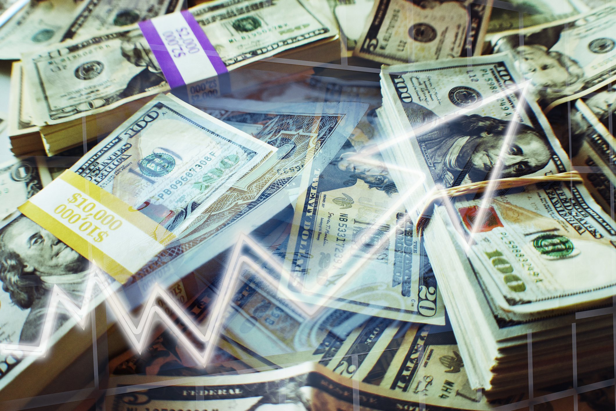 An upward rising arrow superimposed over bundles of cash.