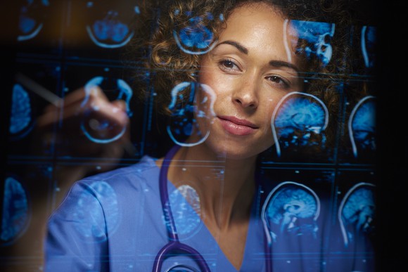 Female doctor analyzing brain scans. 