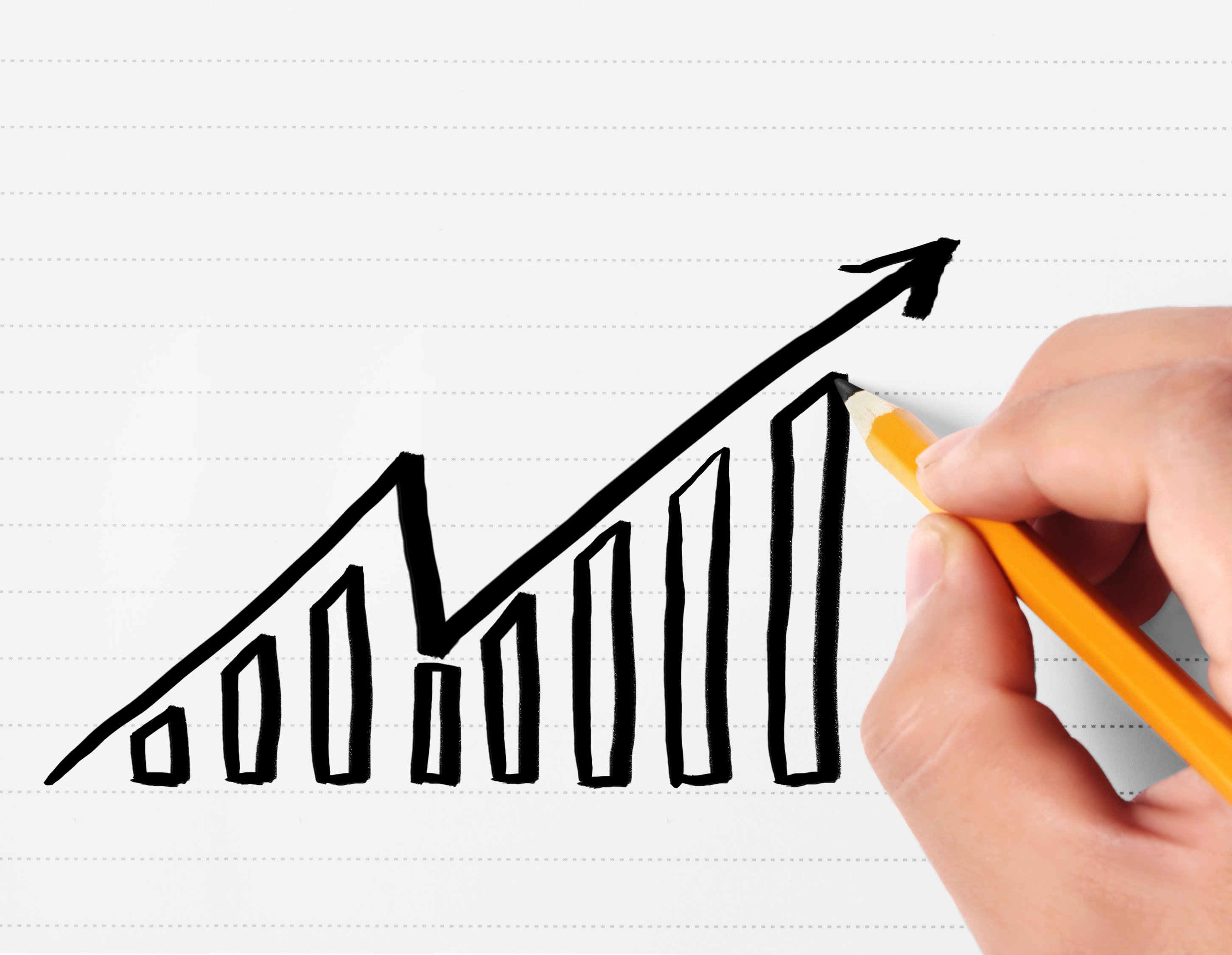 A person is drawing a stock chart that rises, then falls, then rises again.