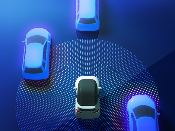 A self-driving vehicle concept showing a robotic vehicle detecting other cars on the road with sensors.