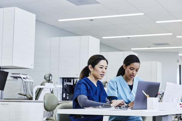 Two students looking at a computer.