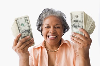 Older woman holding money. 