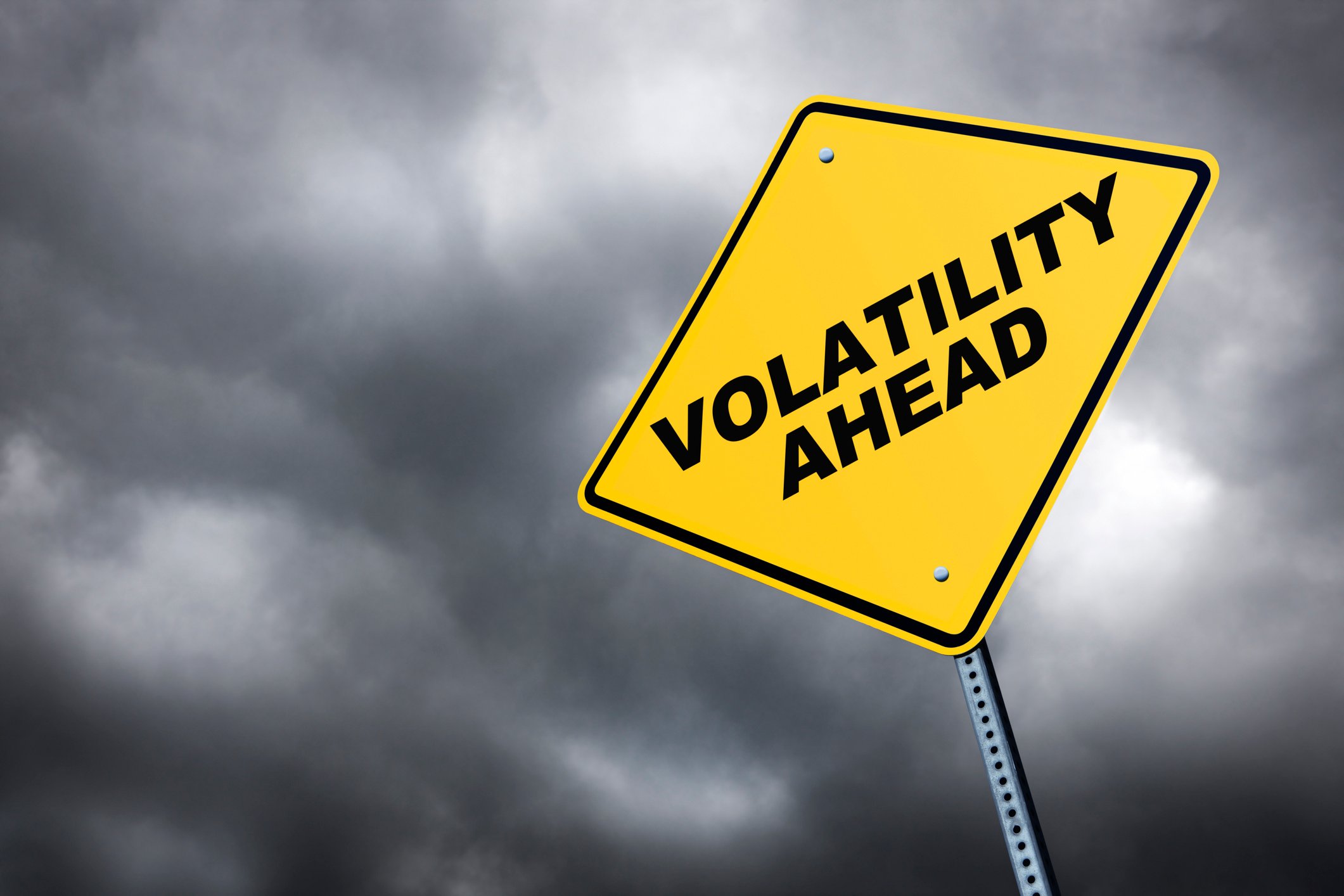 "Volatility ahead" on a street sign with dark clouds in the background