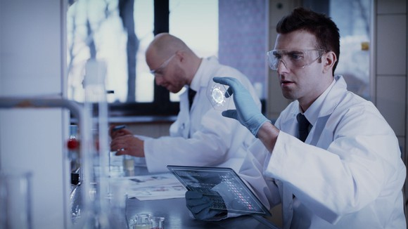 Scientists work in front of computers on coronavirus vaccine development.