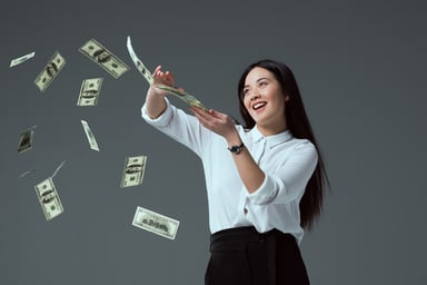 Smiling woman scattering $100 bills