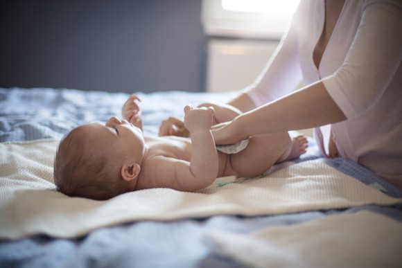 A woman changing a baby's diaper
