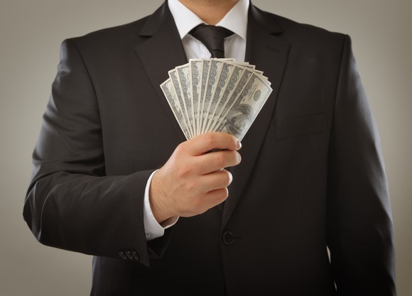 man holding $1000 in cash
