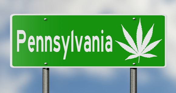 Pennsylvania road sign with marijuana leaf graphic.