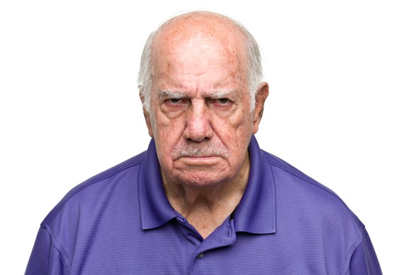 Elderly man frowning.
