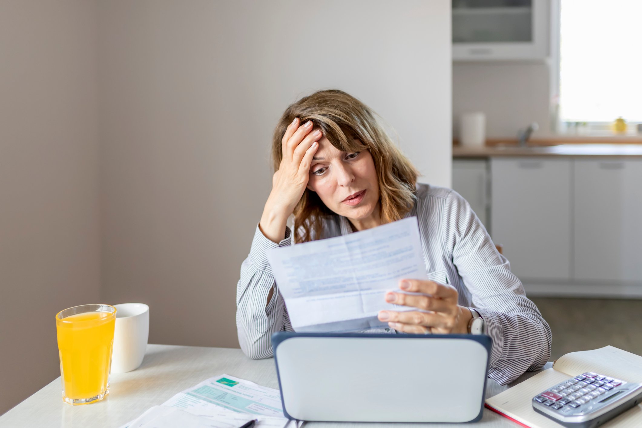 GettyImages-woman looking at bills