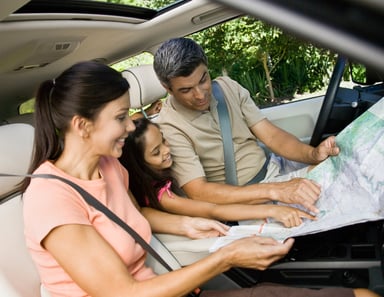 GettyImages-family looking at map in car