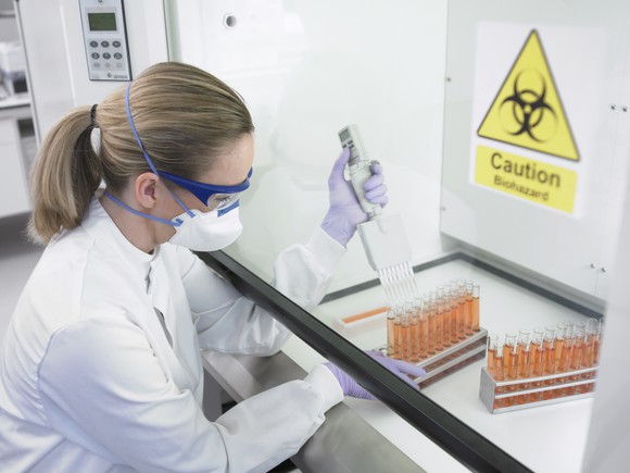 Scientist examining biohazardous liquid. 
