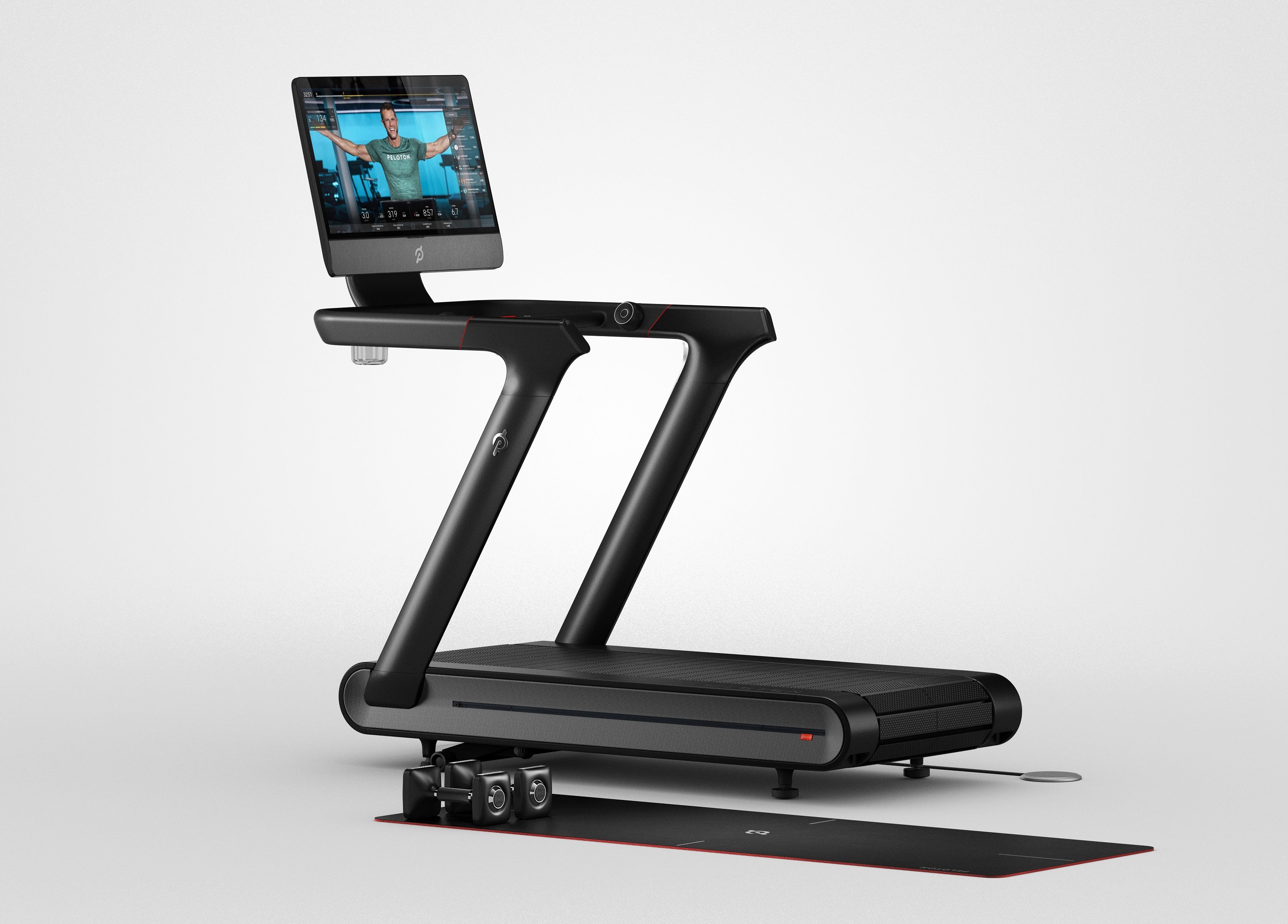 A Peloton Tread+ treadmill with a video screen showing a fitness instructor.