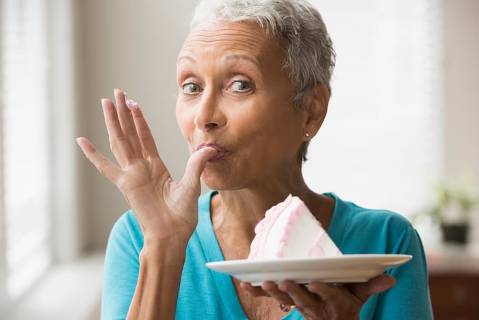 Older woman eating cake 