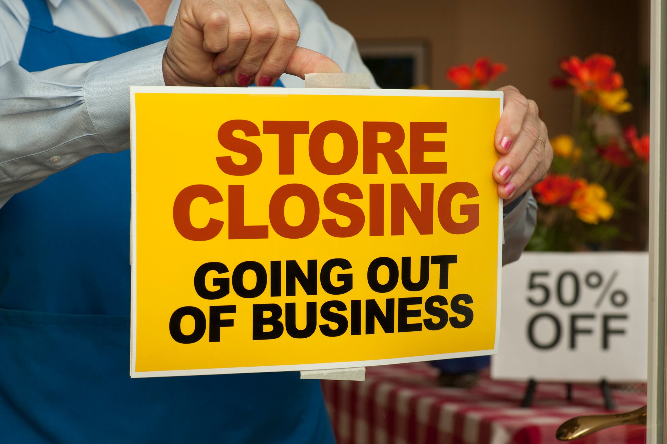 "store closing" sign in the window