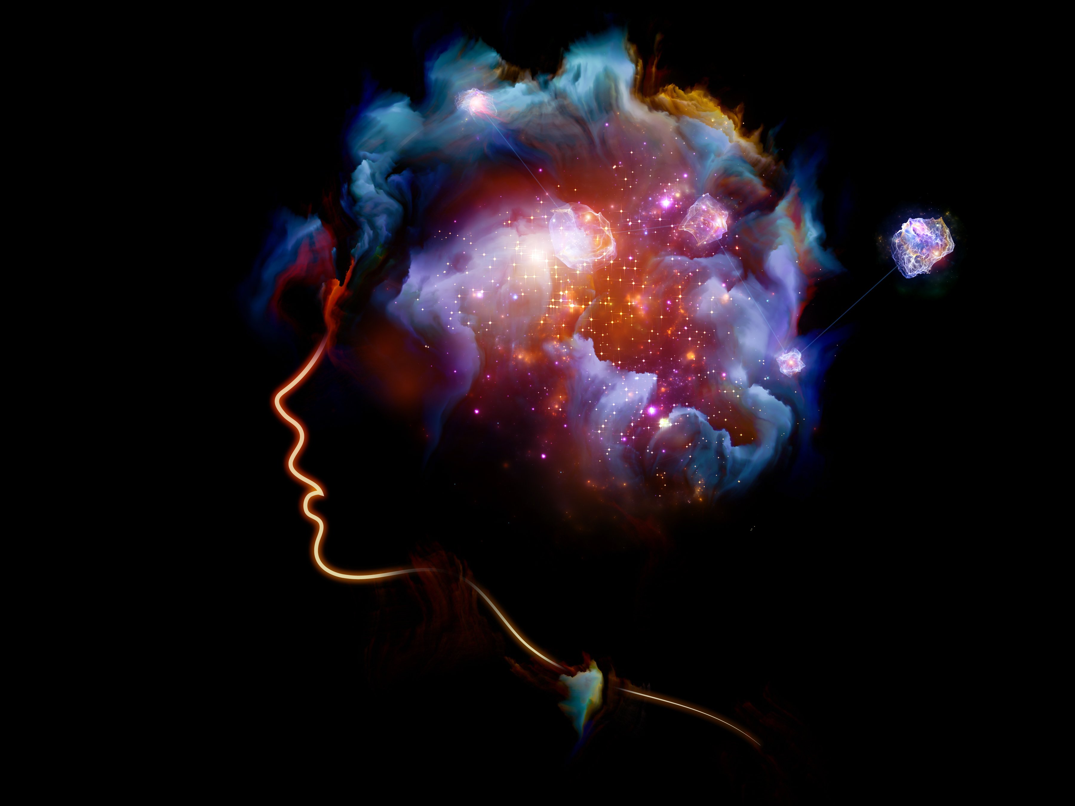 Creative art displaying the profile of human face with colorful nebulae inside the head.