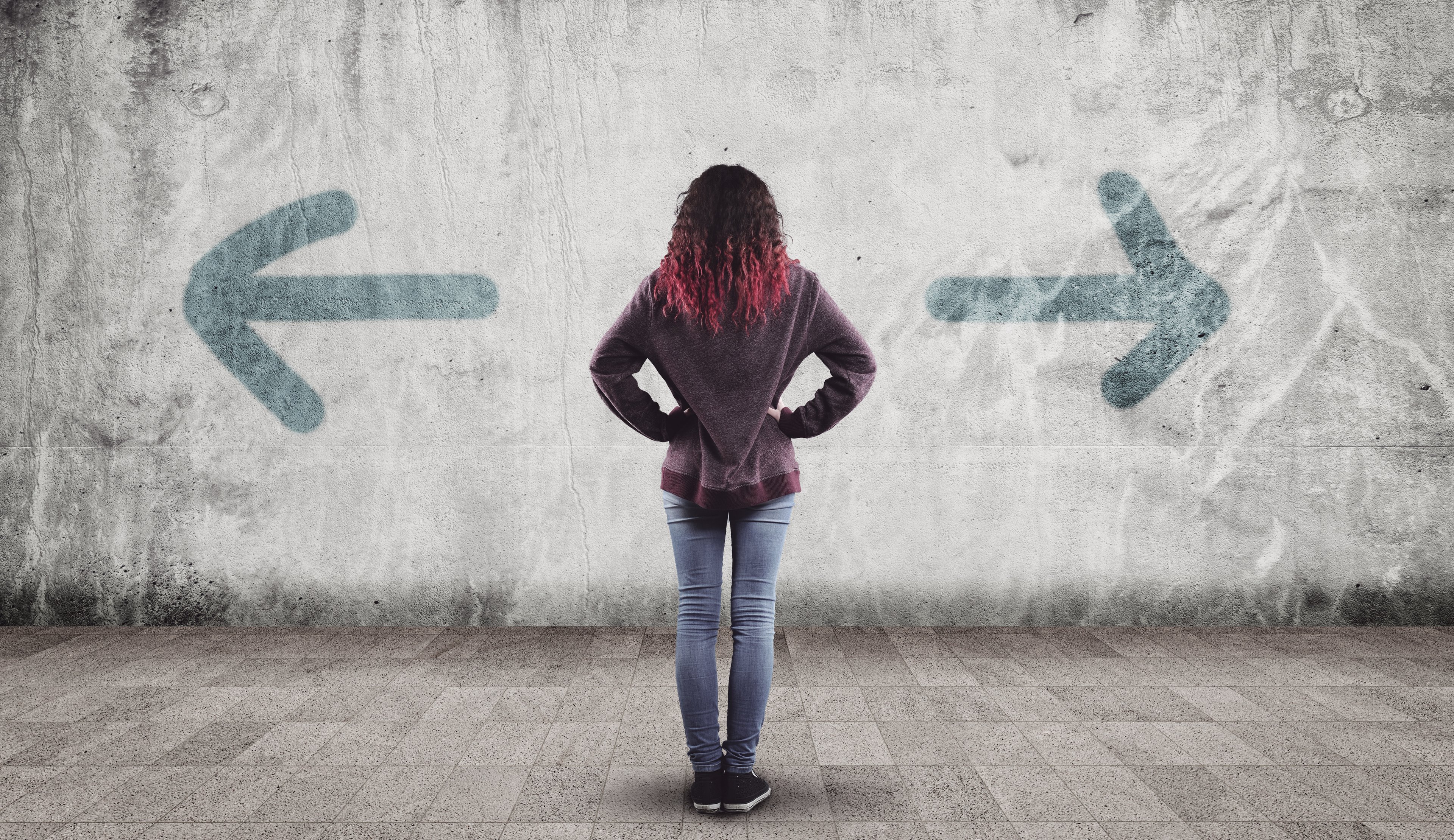 2 arrows on wall with young woman