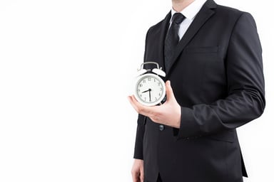 Businessman holding clock