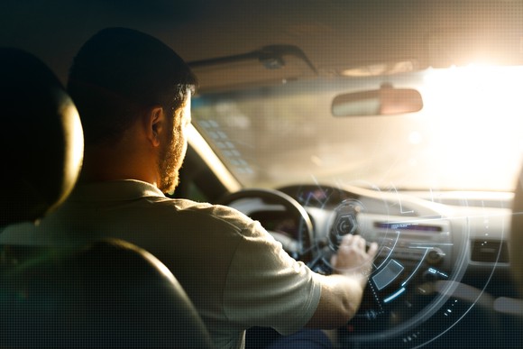 A man accesses digital services on his vehicle's dashboard.