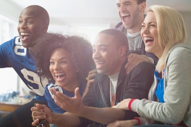 A group pf people watching TV