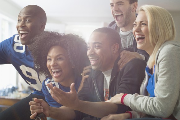 A group pf people watching TV.