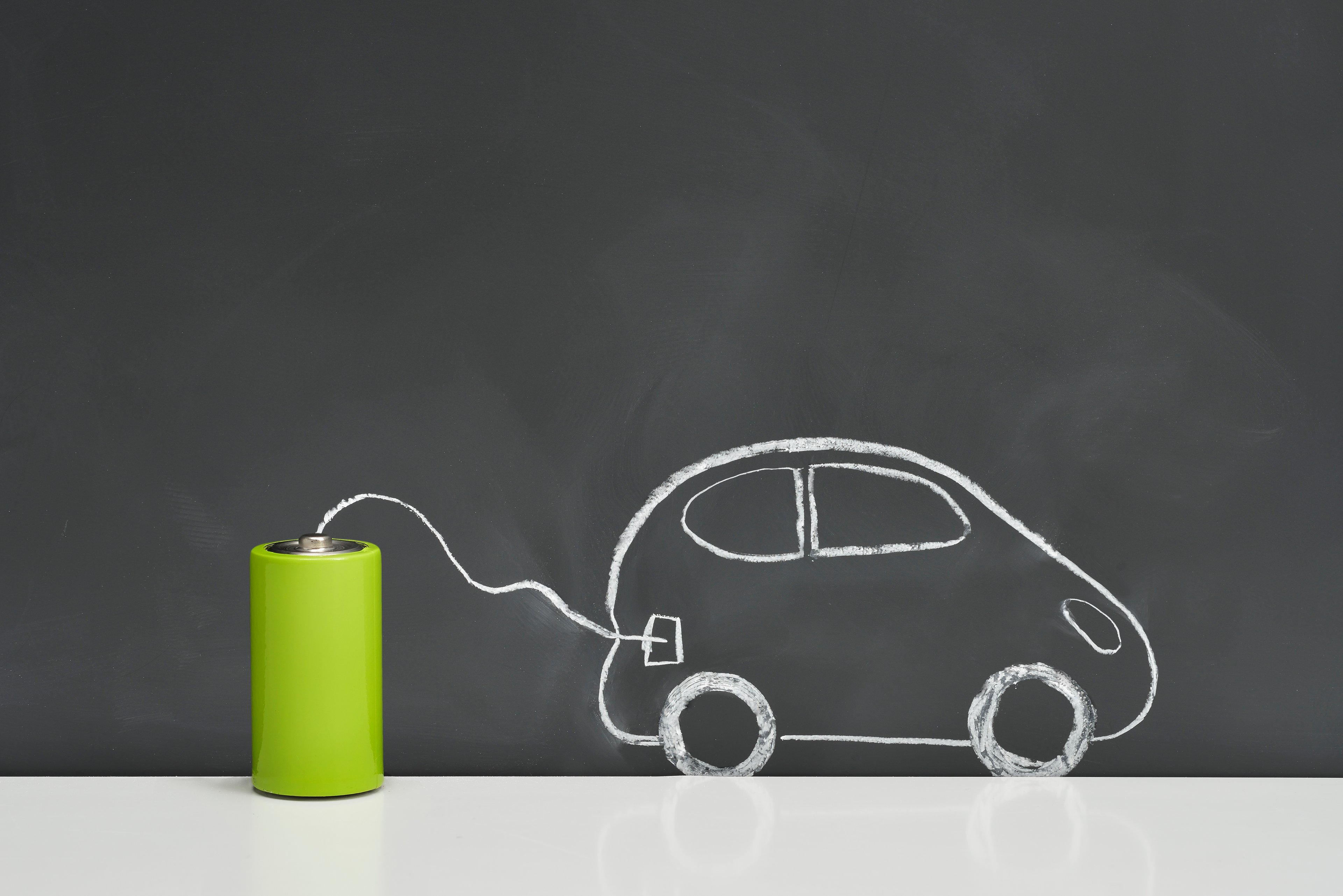 A chalkboard drawing of a car plugged into a battery.