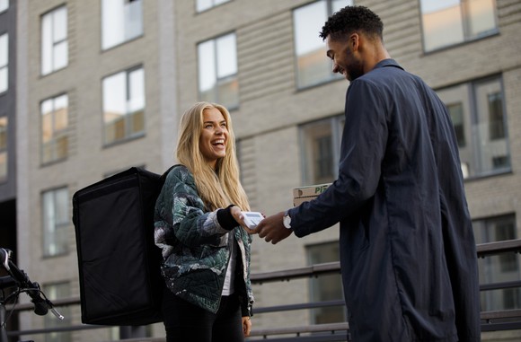 A person paying for a delivery.