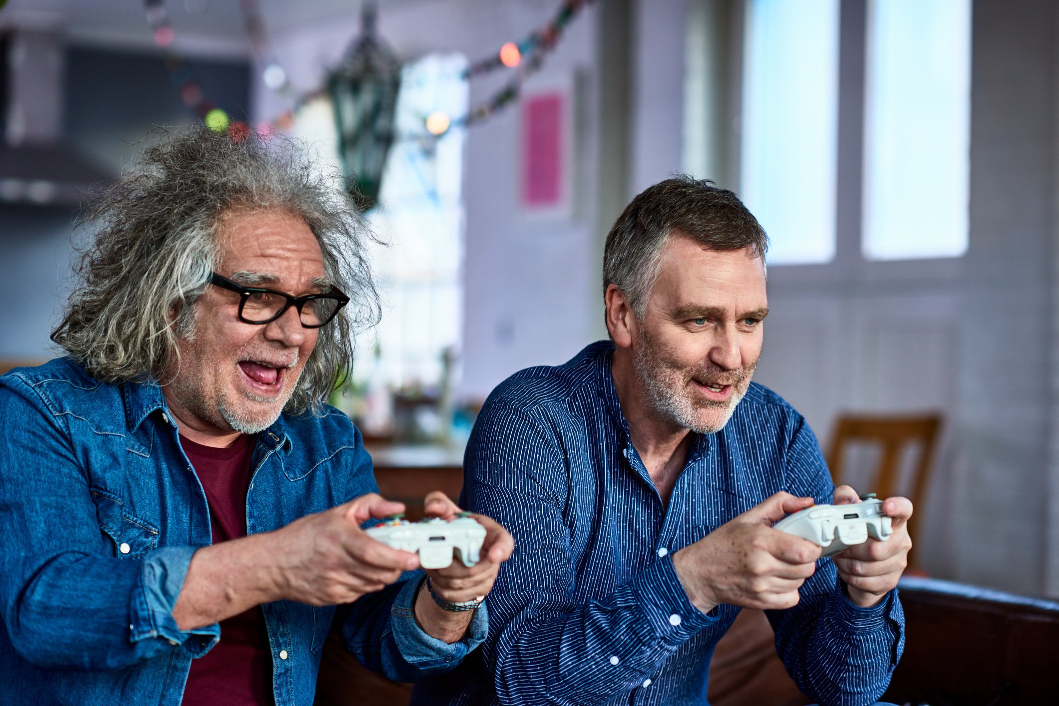 Two senior citizens playing a video game