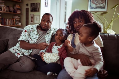 GettyImages-family watching movie at home