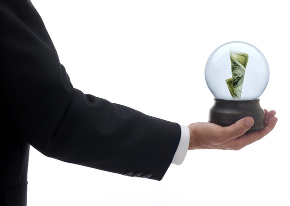 Man holding crystal ball with cash inside.