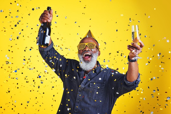 A senior man parties with Champagne.
