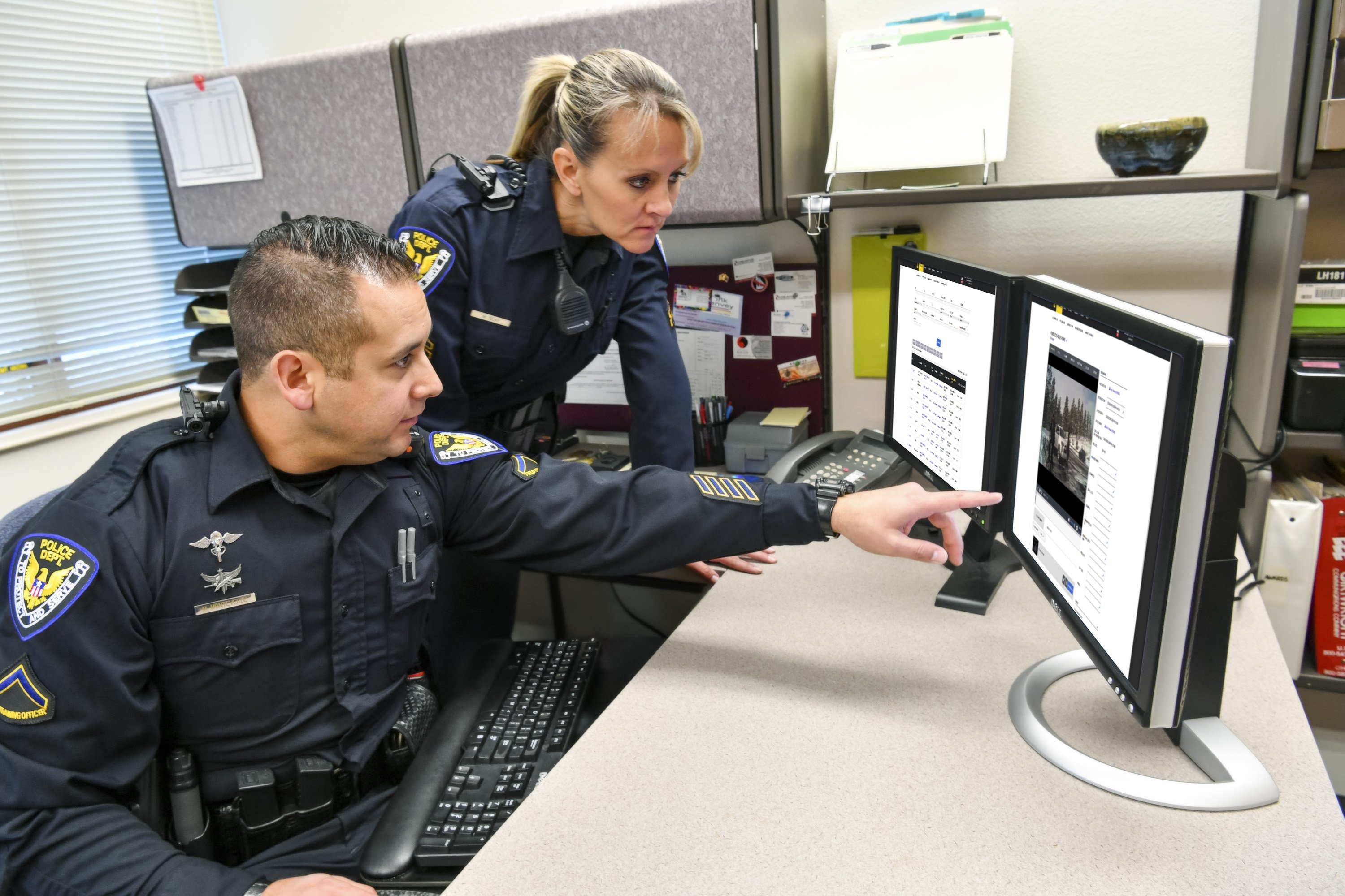 Two law enforcement officers review information stored on Evidence.com.