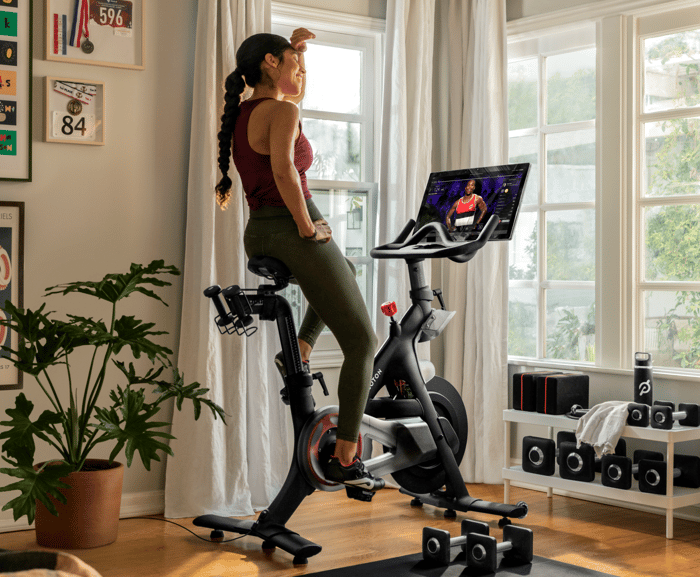 woman on Peloton exercise bike at home