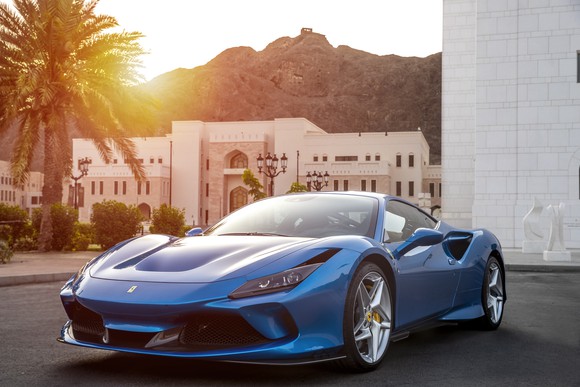 A blue Ferrari F8 Tributo, a mid-engined two-seat V8-powered sports car. 