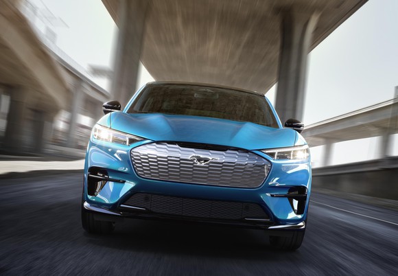 A blue Ford Mustang Mach-E, a sporty electric crossover.
