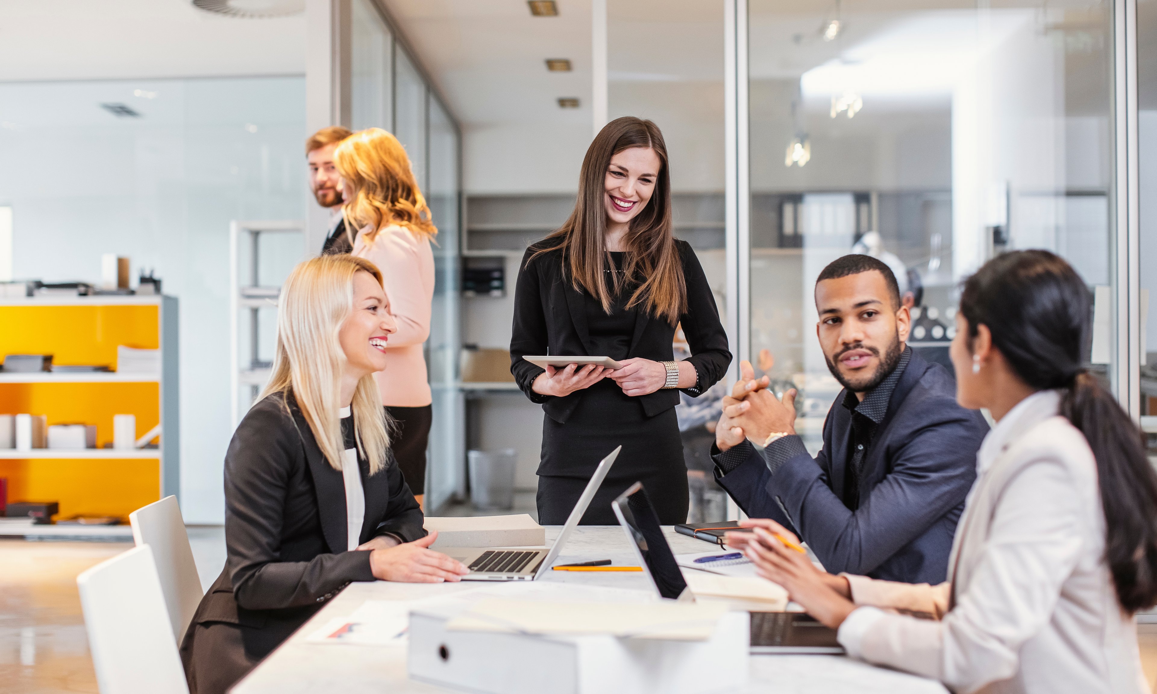 Multinational team present at a sales pitch. 