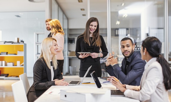 Multinational team present at a sales pitch. 