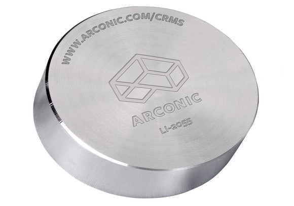 Metal round with Arconic logo imprinted on it.