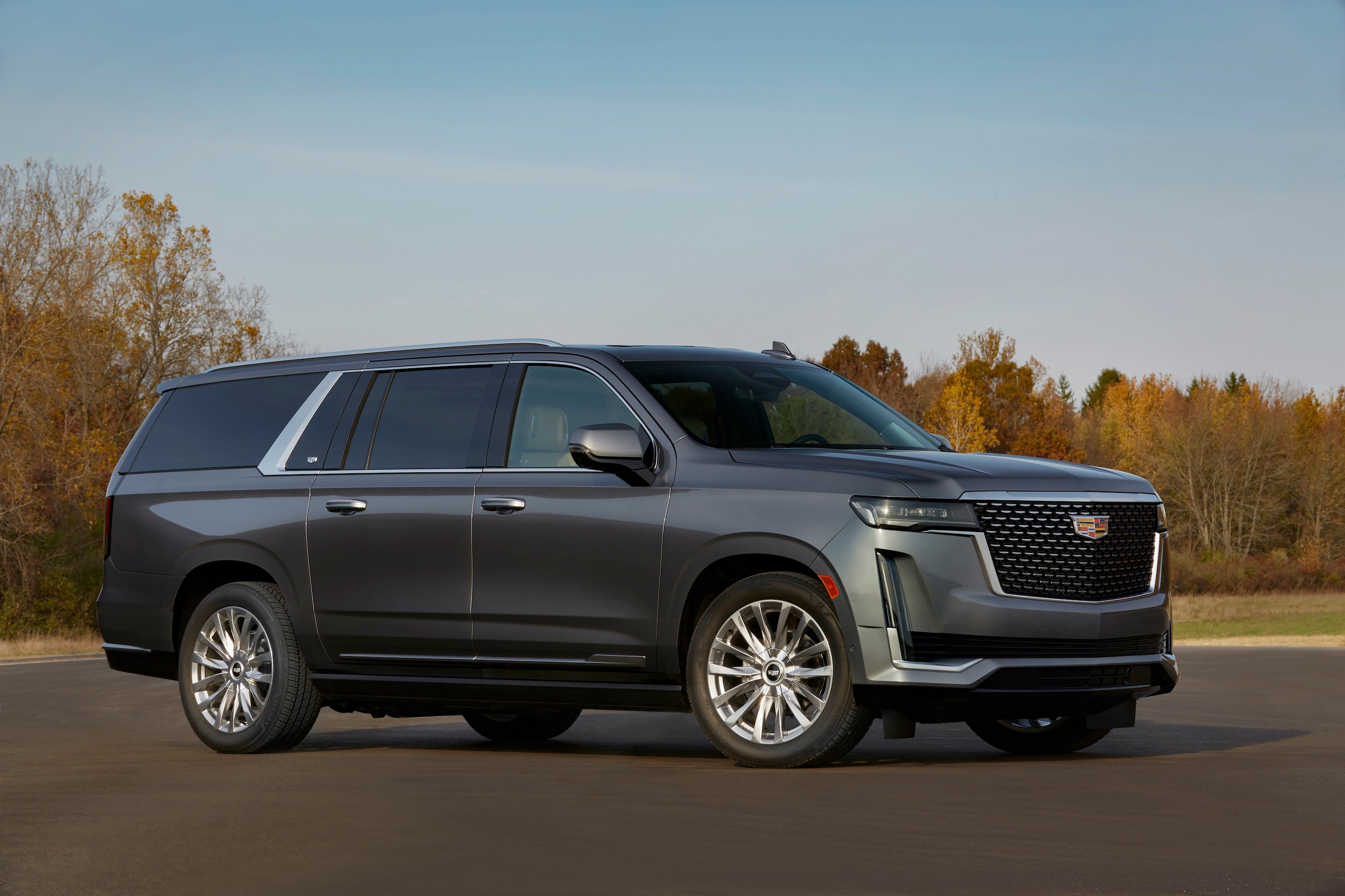 A dark silver 2021 Cadillac Escalade, a large truck-based luxury SUV. 