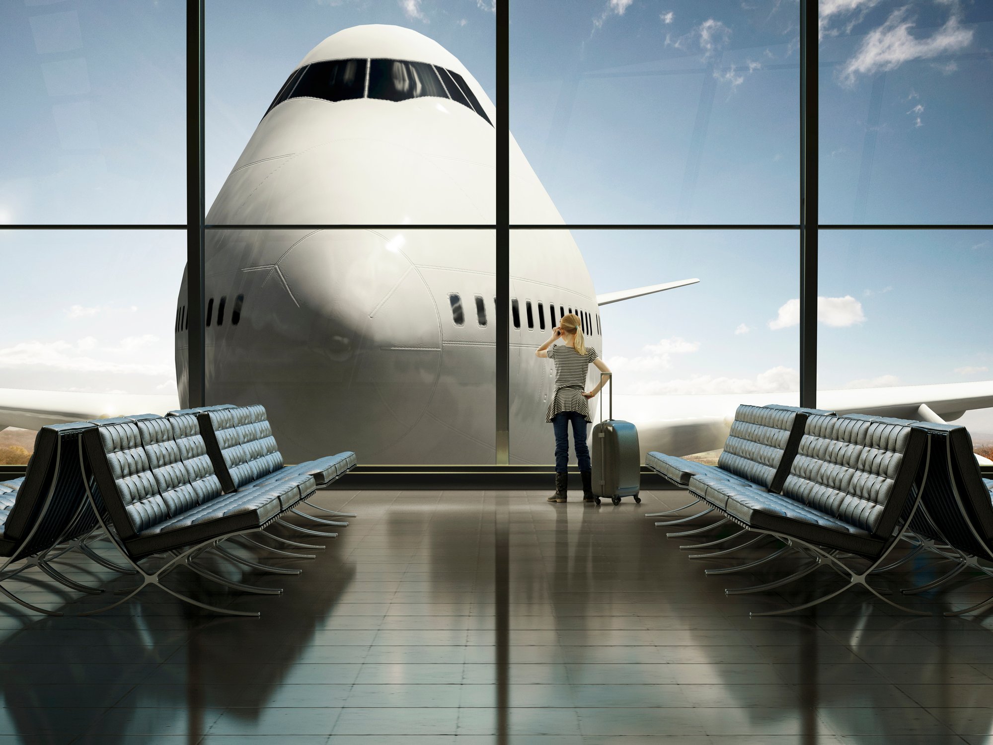 Picture of lone woman in terminal looking out window at a plane. 