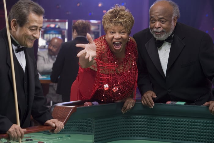 Couple throwing dice at craps table