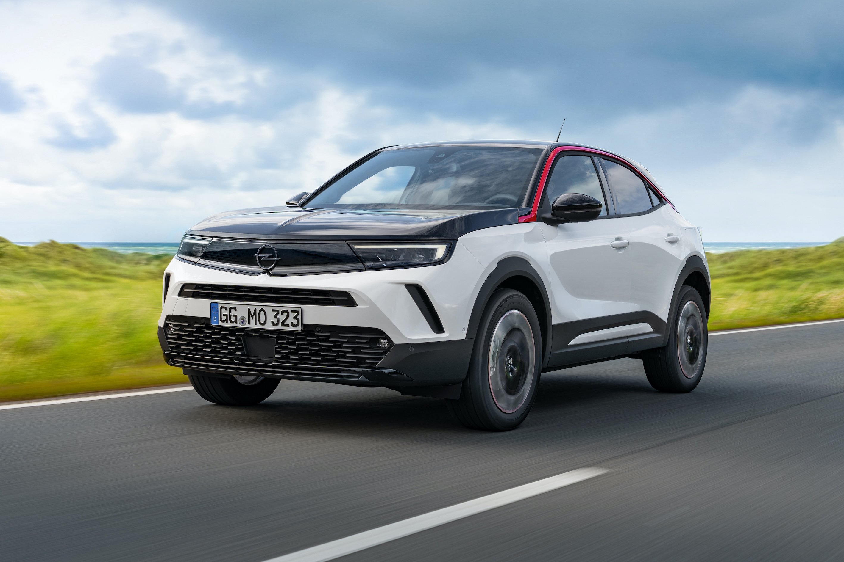 A white and black 2021 Opel Mokka, a compact crossover SUV sold in Europe and Asia. 